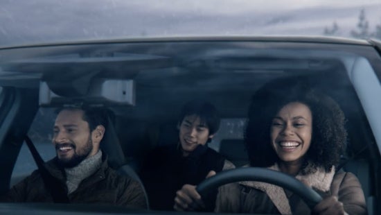 Three passengers riding in a vehicle and smiling | Tom Naquin Nissan in Elkhart IN