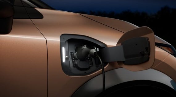 Close-up image of charging cable plugged in | Tom Naquin Nissan in Elkhart IN